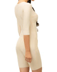 Beige shapewear garment worn by a model on a white background