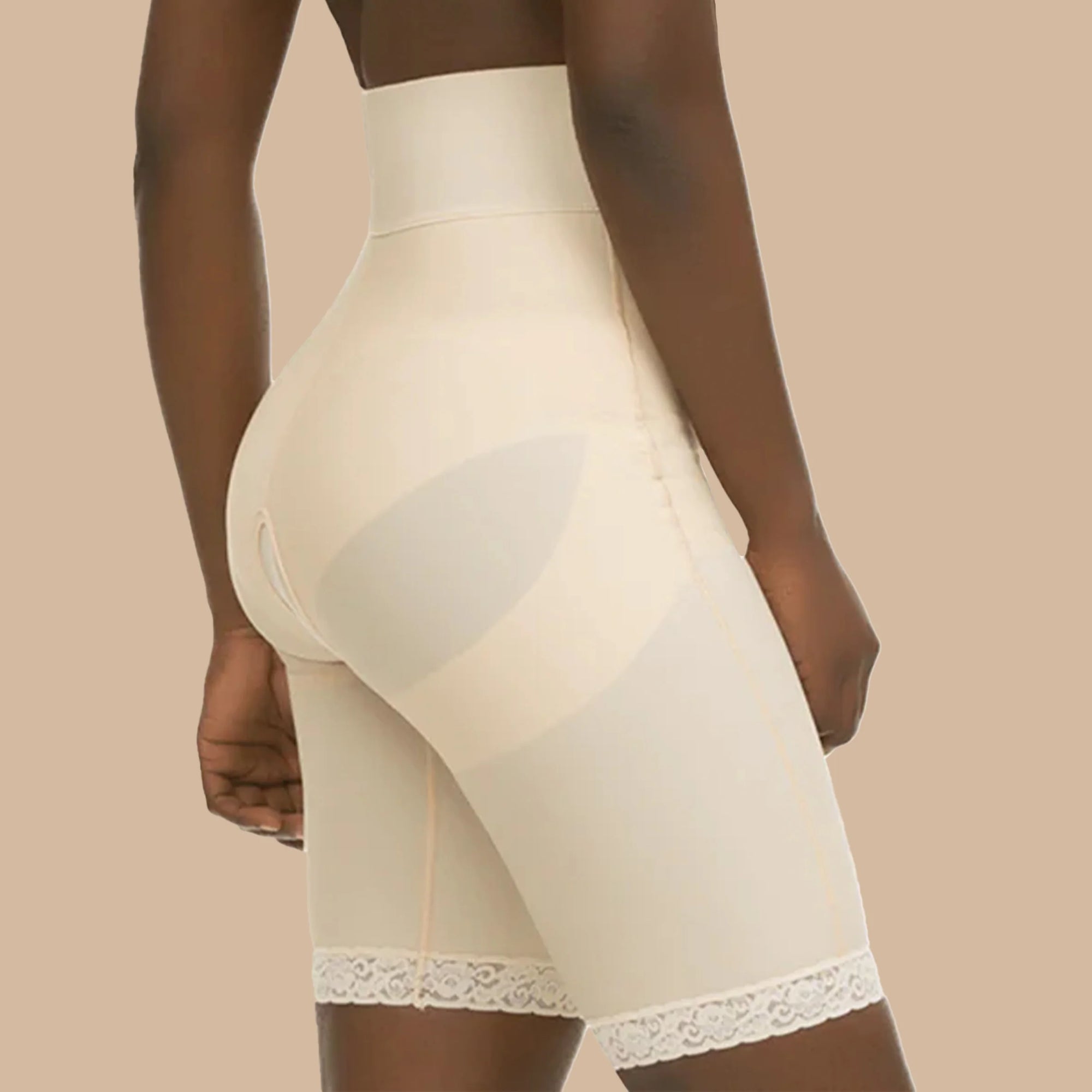 Woman wearing a post-surgical compression girdle with mid-thigh length, high waist, and glute-lifting features for support and shaping during recovery.