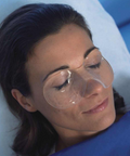 Professional application of Swiss Therapy hydrogel eye masks during a post-surgical facial treatment to reduce swelling and inflammation.
